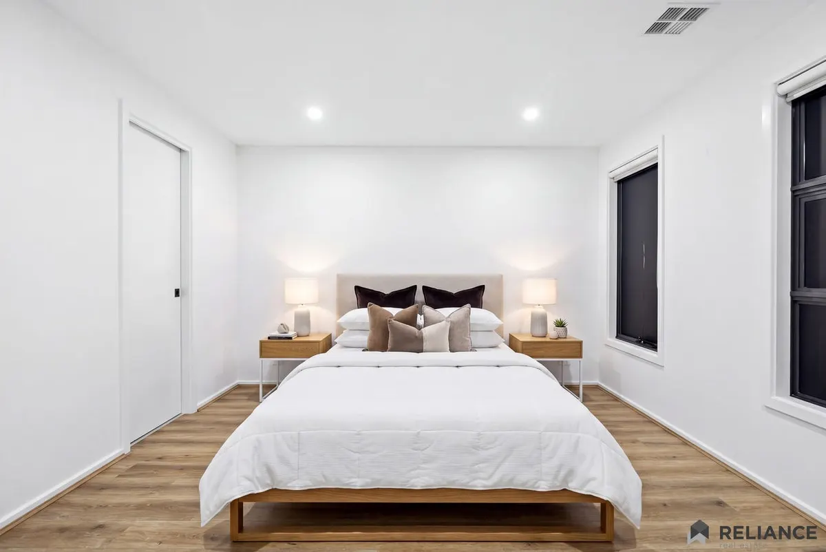 Bedroom with a queen bed and soft neutral furnishings