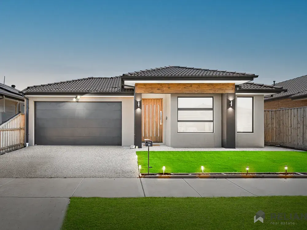 Front of a single-storey house with a double garage and front lawn