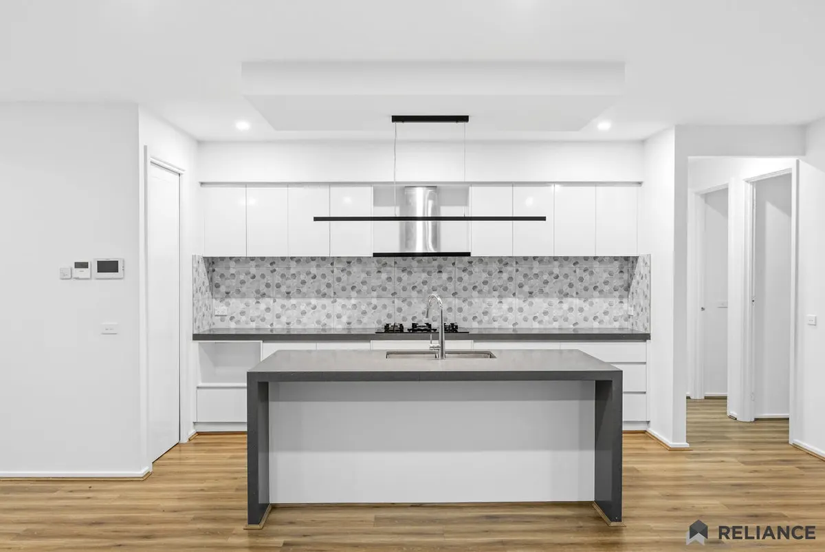 Kitchen with a large island bench and gas cooktop